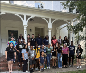 The Shriver LLC & CEL Staff are gathered in front of the Friends of Patterson Park building for a group photo, before they begin service.